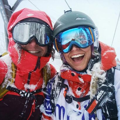 Girlfriends have fun skiing in the ski lift