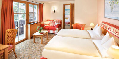 The double bed of the hotel room Snow Princess, with a view of the Alps from the window