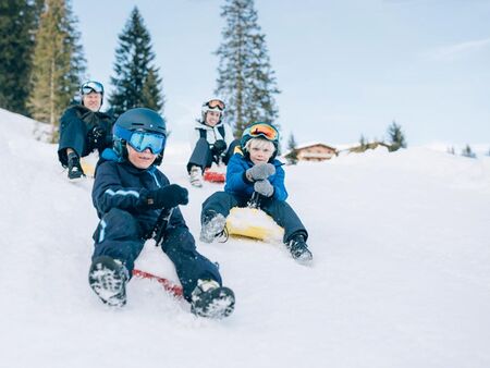 Family has fun tobogganing