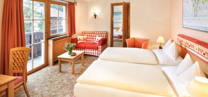 The double bed of the hotel room Snow Princess, with a view of the Alps from the window