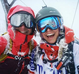 Girlfriends have fun skiing in the ski lift