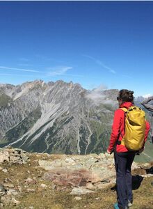 Three people marvel at the view of the mountains