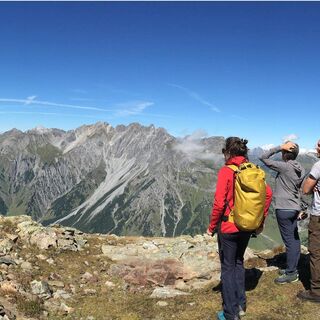 Three people marvel at the view of the mountains