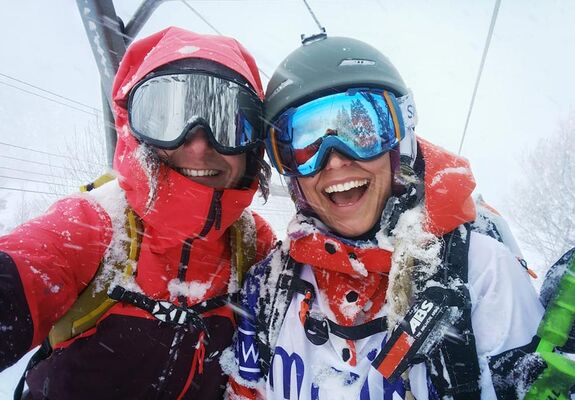 Girlfriends have fun skiing in the ski lift