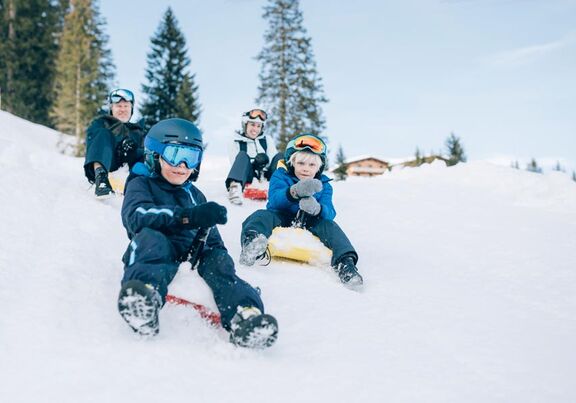 Family has fun tobogganing